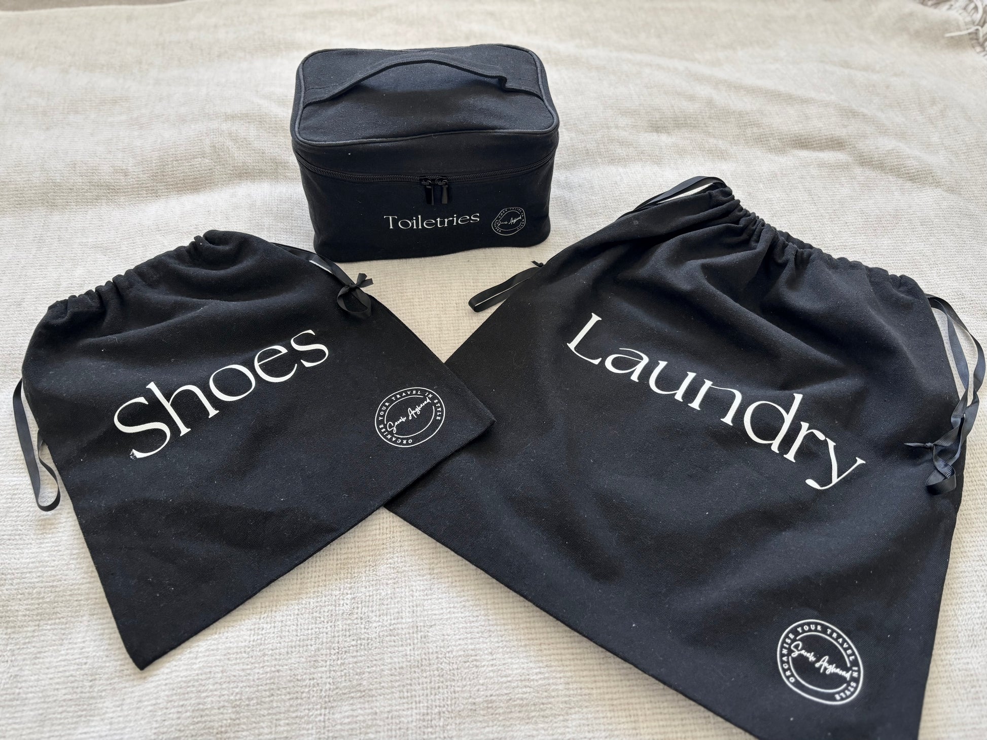 3 black bags, one laundry bag, one shoes bag and one toiletries bag