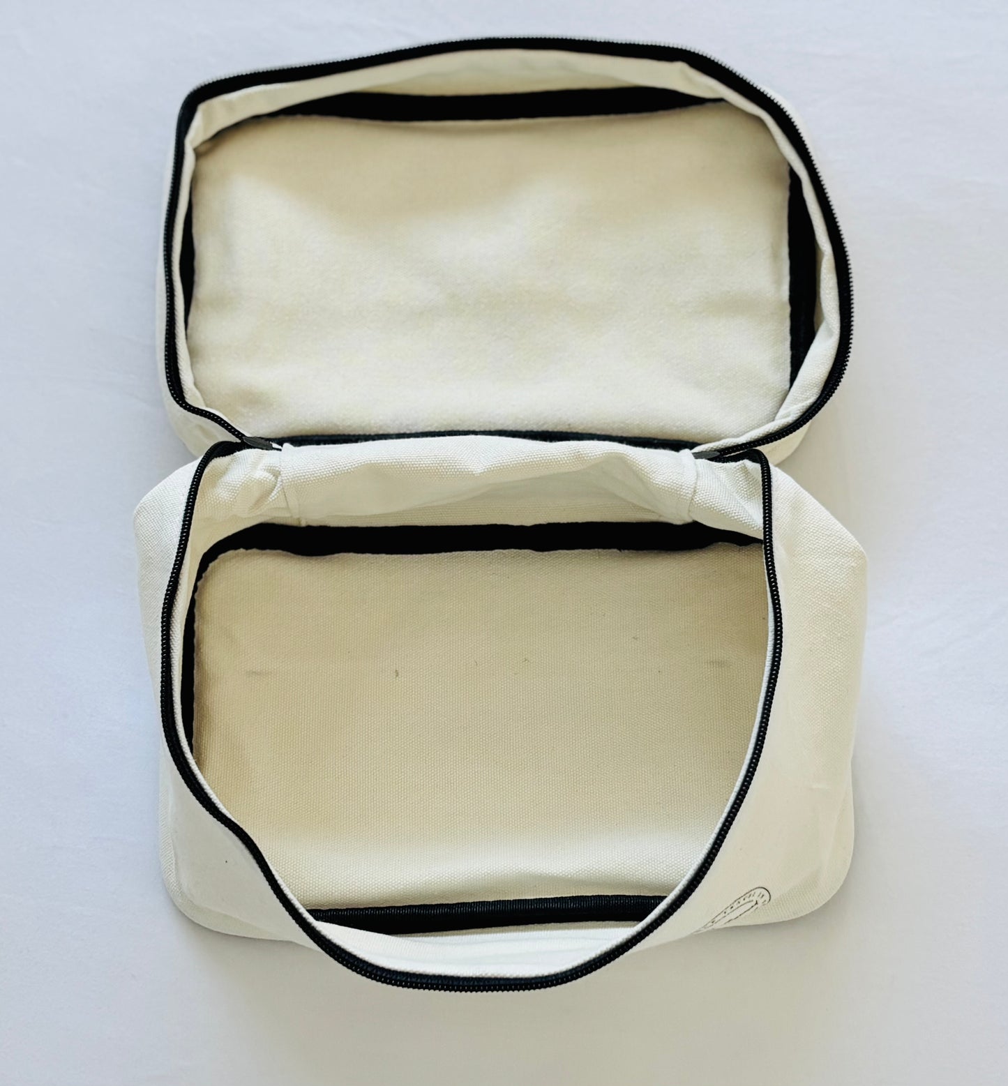 Open cream cotton toiletry bag – interior view for travel essentials