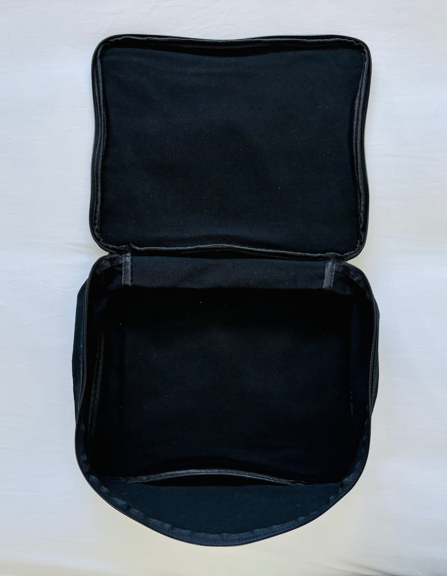 Open Black Packing Cube on a white background showing the inside of the bag