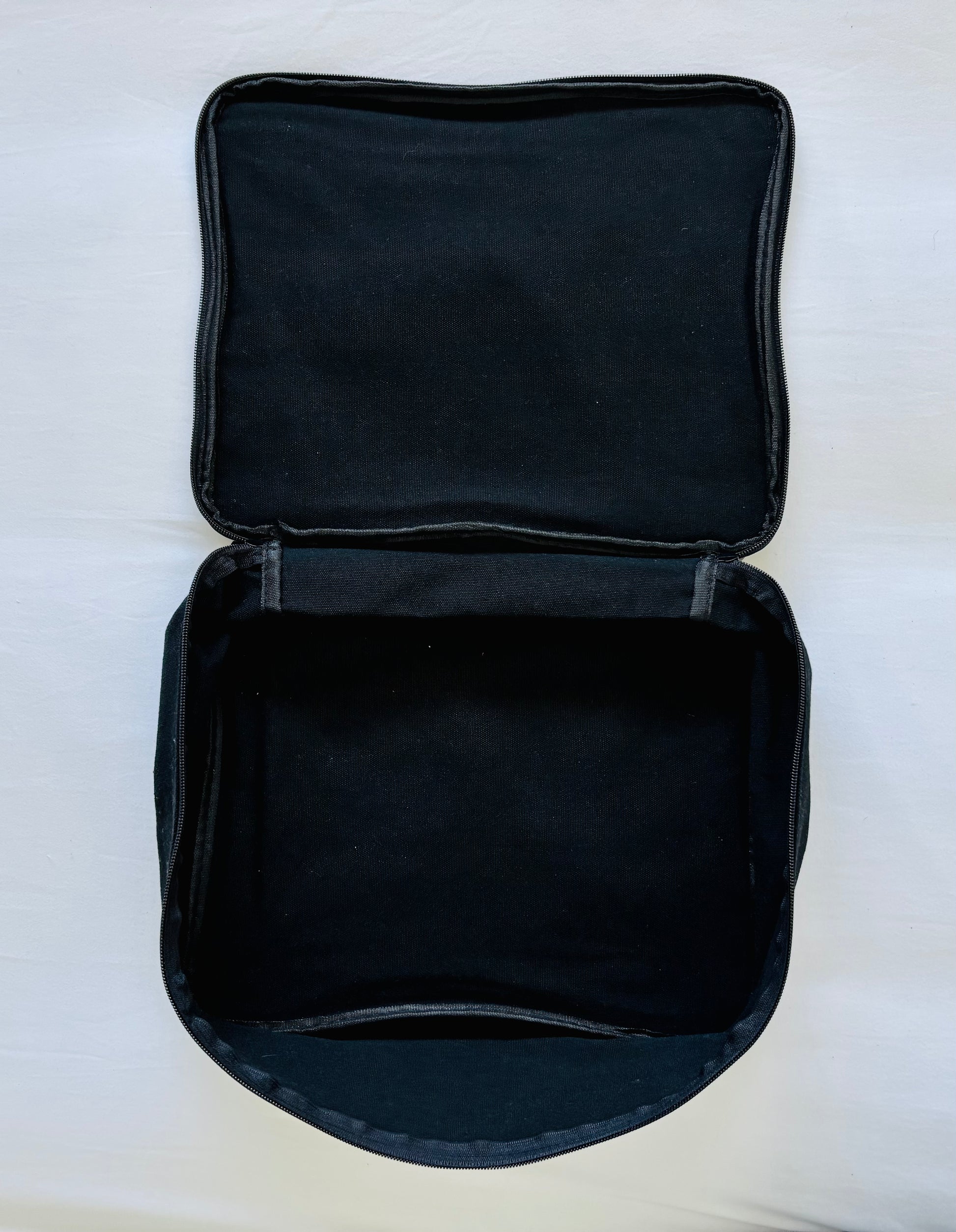 Open Black Packing Cube on a white background showing the inside of the bag
