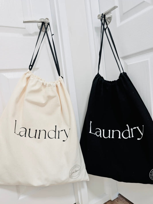One black and one cream laundry bag elegantly hanging on door handles